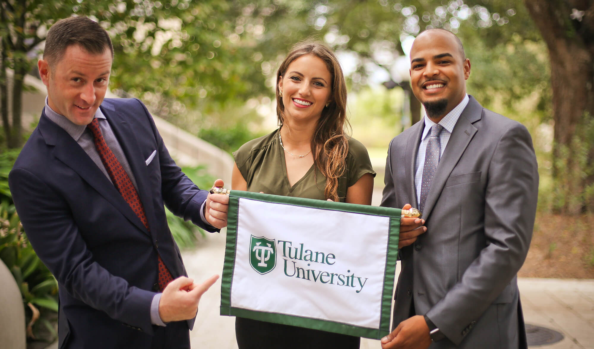 Sopa team members holding Tulane banner