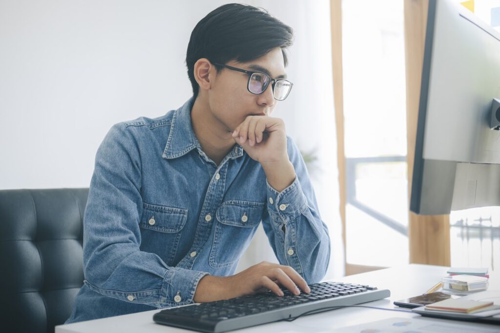 Person sitting at desk working on computer.