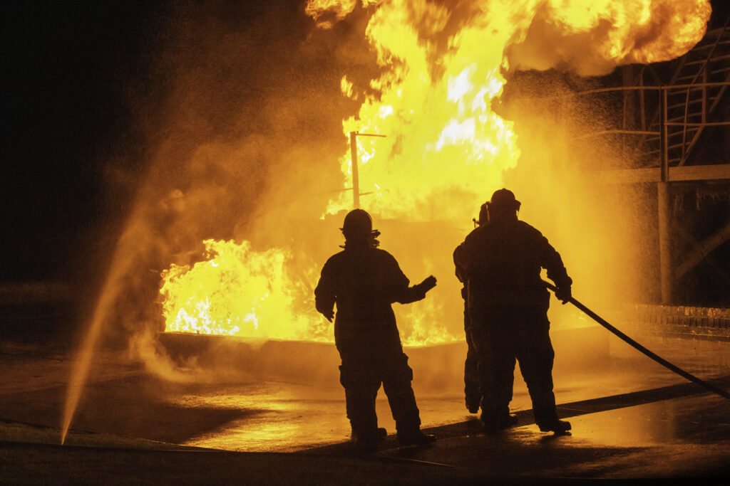 Firefighter first responders extinguishing a wildfire.