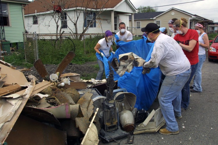 People collectively moving rubble after a disaster.