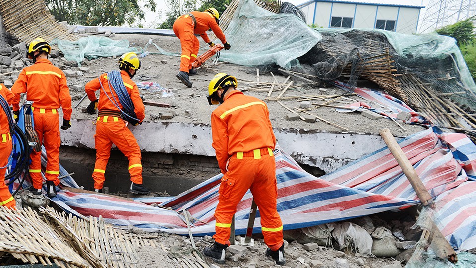 Emergency response leaders showcasing disaster resilience as they clear up a disaster site