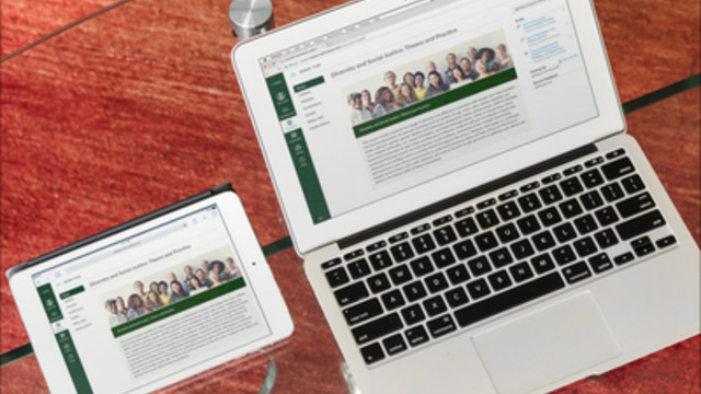 A laptop and tablet sit side by side on a wooden surface both displaying online learning information