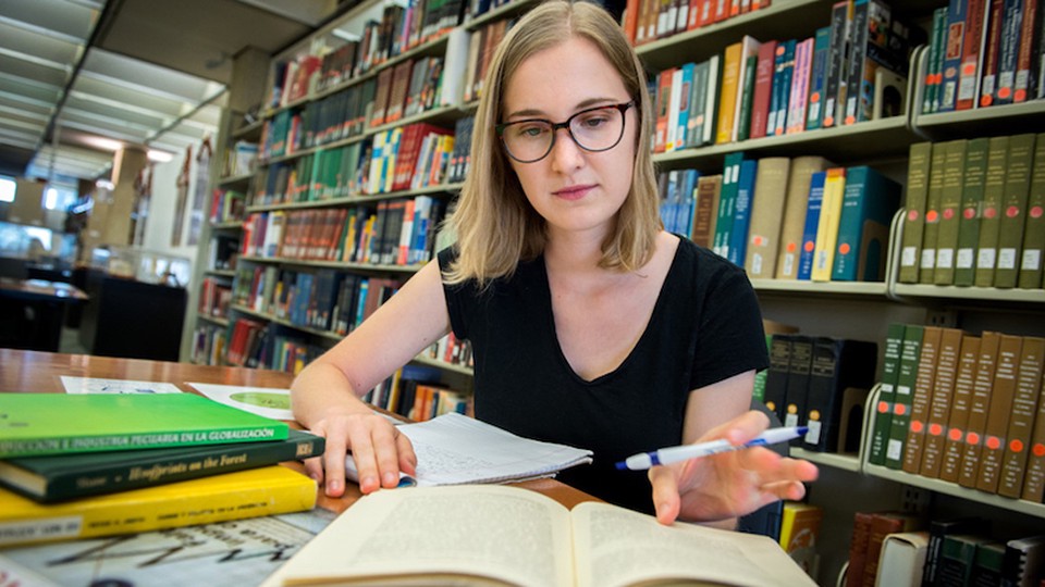 A woman studying at a library.