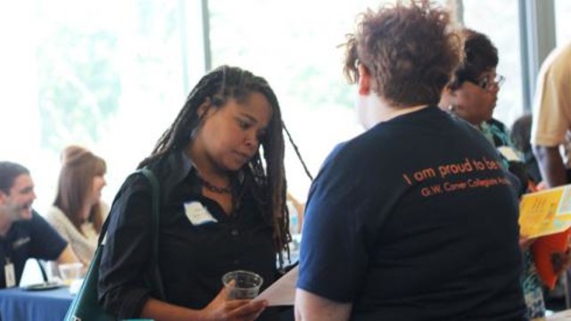 A student speaks with a potential employer at a job fair