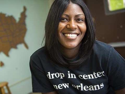 A Tulane Social Work student smiles with a blurred map of the United States in the background