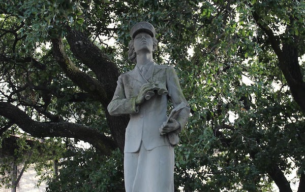 A stone statue of a woman placed on the Tulane University campus