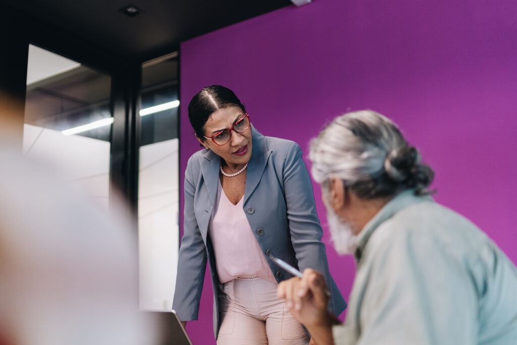 A crisis leader strategizing with a colleague in a conference room.