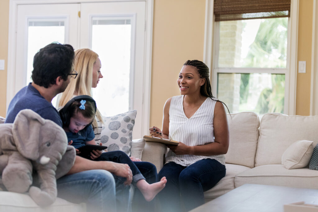 A social worker sitting with a family.