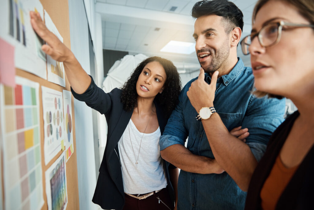 Social workers reviewing policies on a bulletin board.